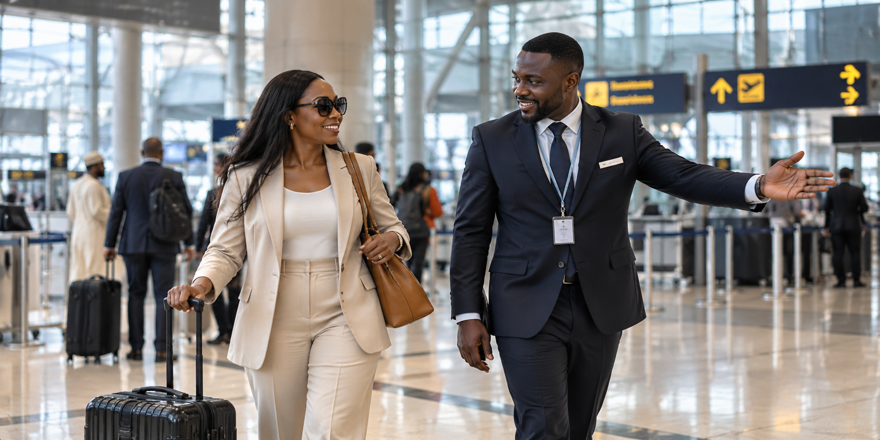 Black airport representative assisting a traveller with luggage in the terminal